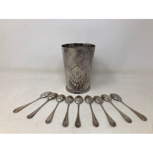 865 - A silver coloured metal mug, and assorted silver and silver plated teaspoons