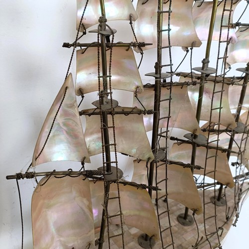 912 - A large mother of pearl veneered model of a ship, 60 cm high