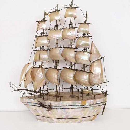 912 - A large mother of pearl veneered model of a ship, 60 cm high