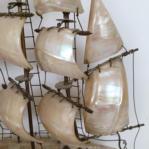 912 - A large mother of pearl veneered model of a ship, 60 cm high