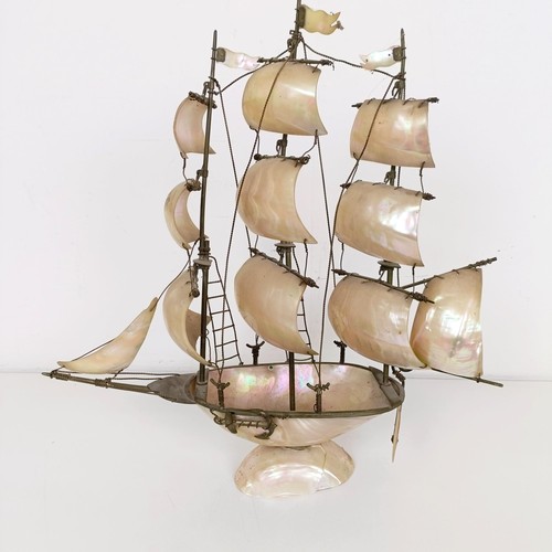 914 - A novelty mother of pearl model of a ship, 39 cm high