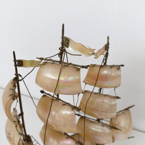 914 - A novelty mother of pearl model of a ship, 39 cm high