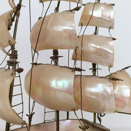 914 - A novelty mother of pearl model of a ship, 39 cm high