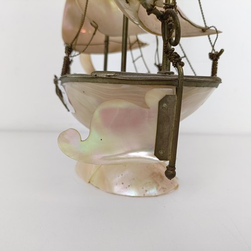 914 - A novelty mother of pearl model of a ship, 39 cm high