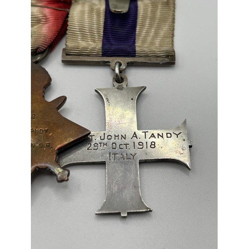 538 - A group of four medals, awarded to Lt John A Tandy, comprising a Military Cross, privately named and... 