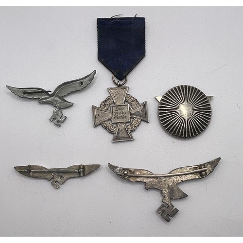 551 - A small group of German Third Reich badges, and a cross