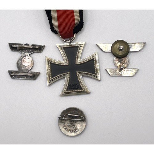 556 - A German Third Reich Iron Cross, and three other badges