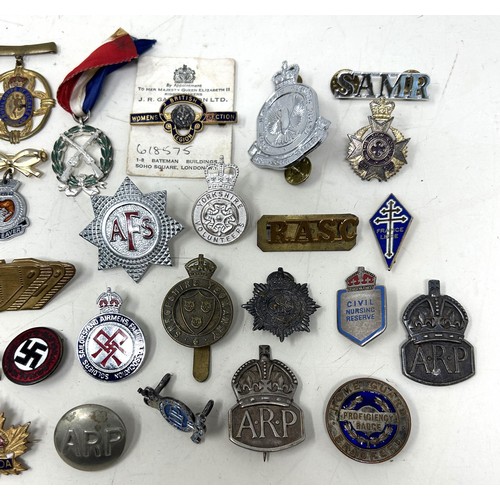 575 - Assorted military and other badges and brooches, including ARP