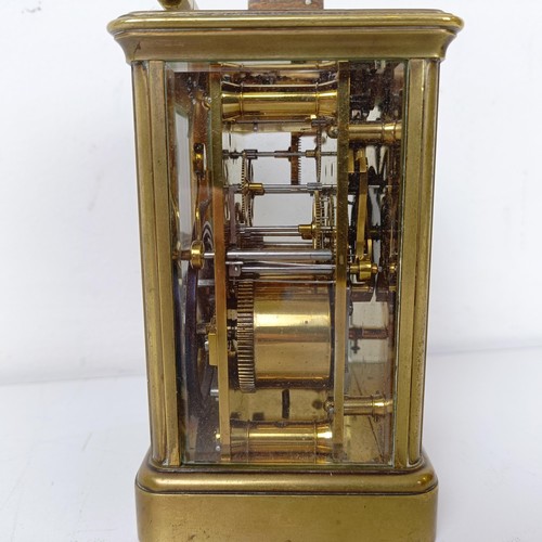 971 - A carriage clock, with repeat, in a brass and glass case, 18 cm high