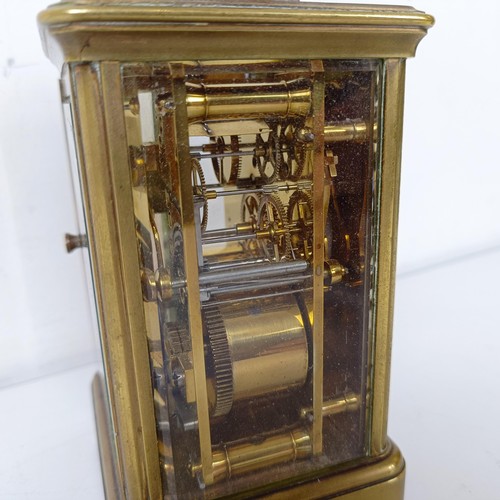 971 - A carriage clock, with repeat, in a brass and glass case, 18 cm high