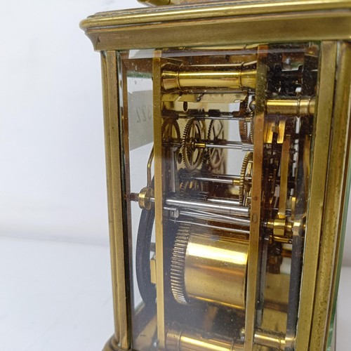 971 - A carriage clock, with repeat, in a brass and glass case, 18 cm high