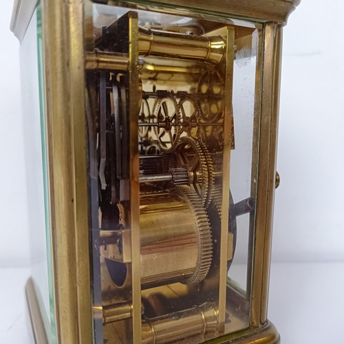 971 - A carriage clock, with repeat, in a brass and glass case, 18 cm high