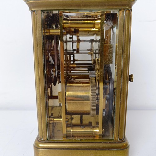 971 - A carriage clock, with repeat, in a brass and glass case, 18 cm high