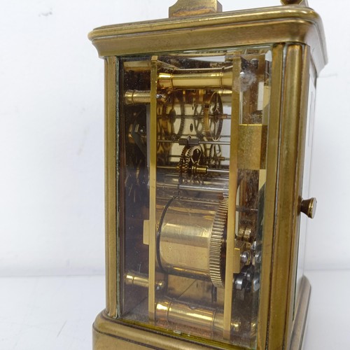 971 - A carriage clock, with repeat, in a brass and glass case, 18 cm high