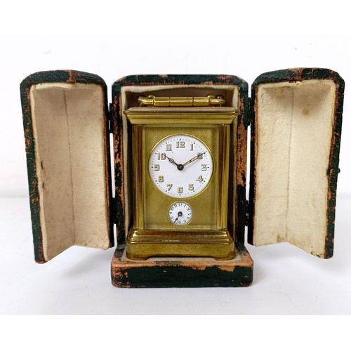 972 - A miniature carriage clock, with alarm, the enamel dial,  with Arabic numerals, in a brass and glass... 