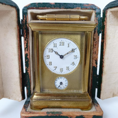 972 - A miniature carriage clock, with alarm, the enamel dial,  with Arabic numerals, in a brass and glass... 