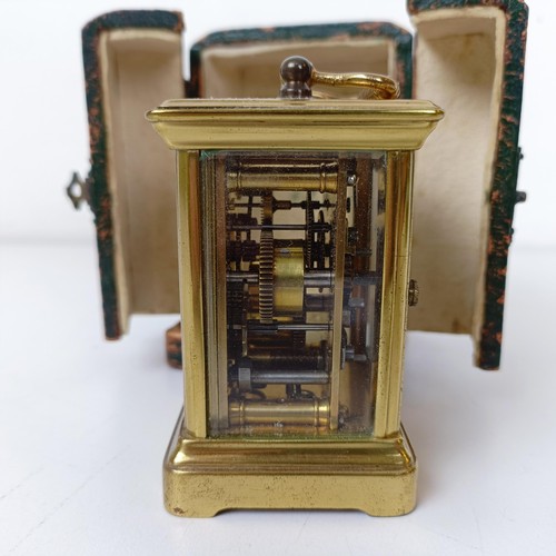 972 - A miniature carriage clock, with alarm, the enamel dial,  with Arabic numerals, in a brass and glass... 