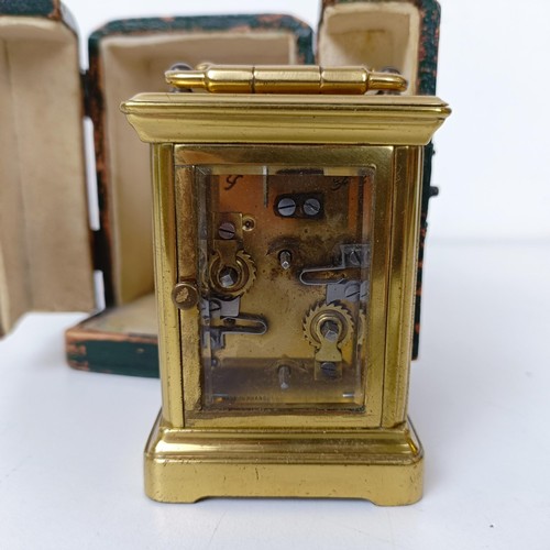 972 - A miniature carriage clock, with alarm, the enamel dial,  with Arabic numerals, in a brass and glass... 