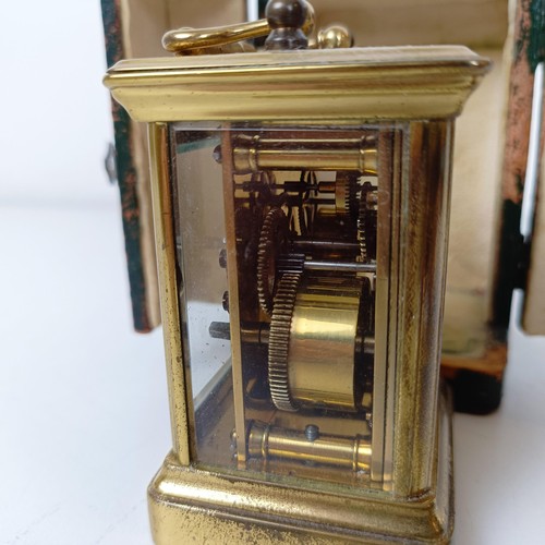 972 - A miniature carriage clock, with alarm, the enamel dial,  with Arabic numerals, in a brass and glass... 