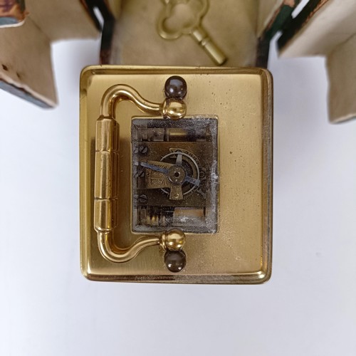 972 - A miniature carriage clock, with alarm, the enamel dial,  with Arabic numerals, in a brass and glass... 