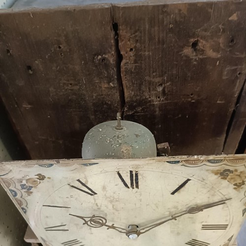 977 - A longcase clock, with a painted dial, fitted a thirty hour movement, in a pine case, 193 cm high