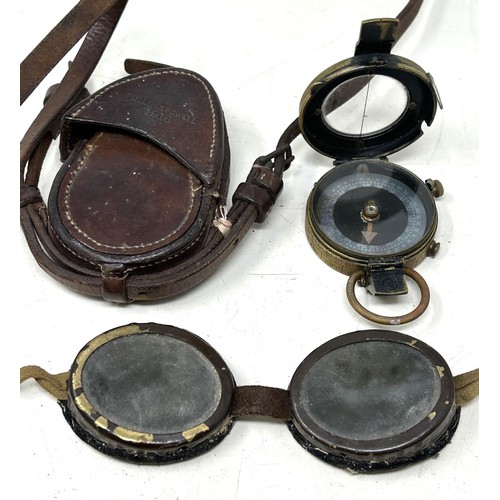 539 - A WWI compass, 1918, in a leather Pulley & Powell 1916 leather case, and a pair of heavily tinte... 