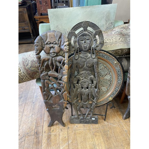 1084 - An Eastern carved plaque, decorated figure, 88 cm high, some losses, an African carved plaque, 100 c... 