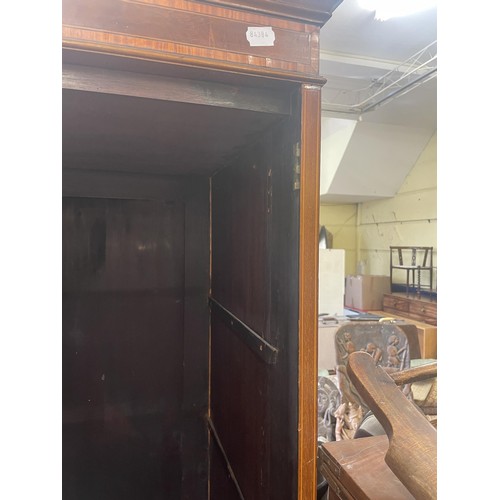 1061 - A mahogany linen press, the top with two cupboard doors, on a base with two short and three graduate... 