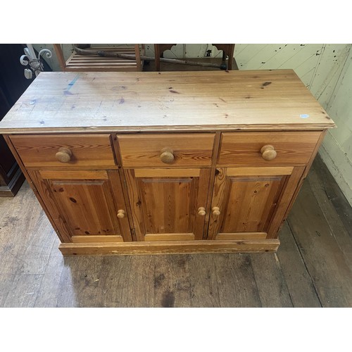 993 - A pine dresser base, 125 cm wide, an oak drop leaf table, a rocking chair, a wine rack, a doll's hig... 