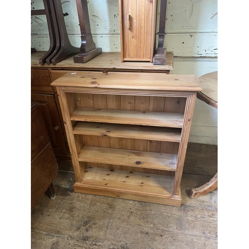 993 - A pine dresser base, 125 cm wide, an oak drop leaf table, a rocking chair, a wine rack, a doll's hig... 