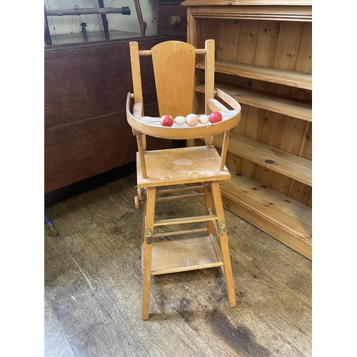 993 - A pine dresser base, 125 cm wide, an oak drop leaf table, a rocking chair, a wine rack, a doll's hig... 