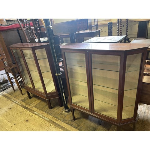 1004 - A pair of walnut display cabinets, 108 cm wide, and a walnut chest of four drawers (3)