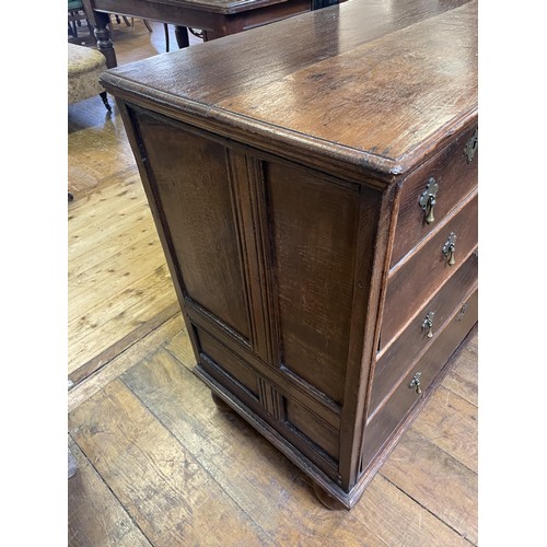 1025 - An oak chest, having two short and three long drawers, 102 cm wide