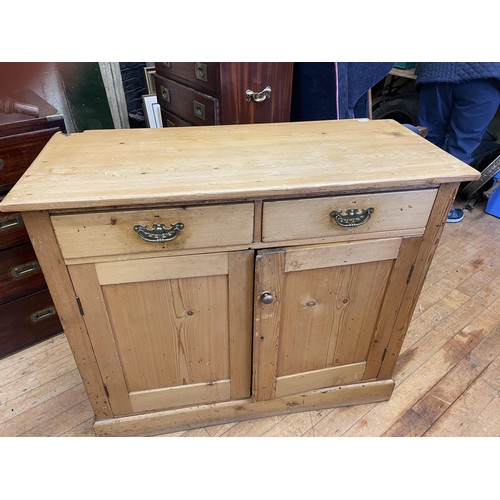 1073 - A pair of military style bedside chests, having a brushing slide and three drawers, a pine cupboard,... 