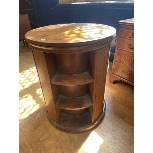 1050 - An oak revolving bookcase, 64 cm diameter, a tray top commode, another, two lamps and a triptych mir... 