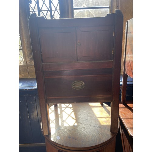 1050 - An oak revolving bookcase, 64 cm diameter, a tray top commode, another, two lamps and a triptych mir... 