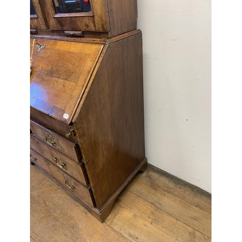 999 - A late 18th/early 19th century walnut bureau bookcase, the top having two mirrored doors above two c... 