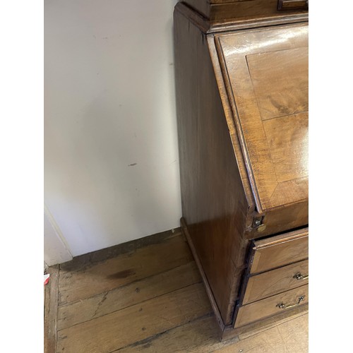 999 - A late 18th/early 19th century walnut bureau bookcase, the top having two mirrored doors above two c... 