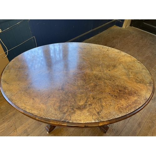 1088 - A Victorian walnut oval table, 125 cm wide, a side table, inset with with an embroidered panel, a co... 