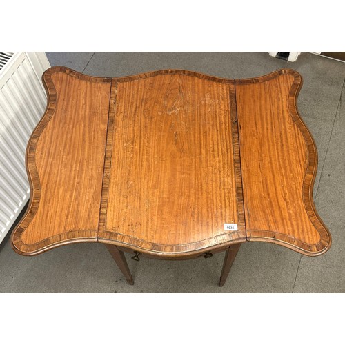 1035 - A 19th century satinwood butterfly top Pembroke table, with rosewood crossbanding, having a single d... 