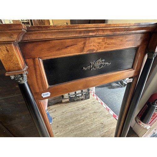 1002 - A walnut and ebonised pier mirror, with column supports, 110 x 69 cm