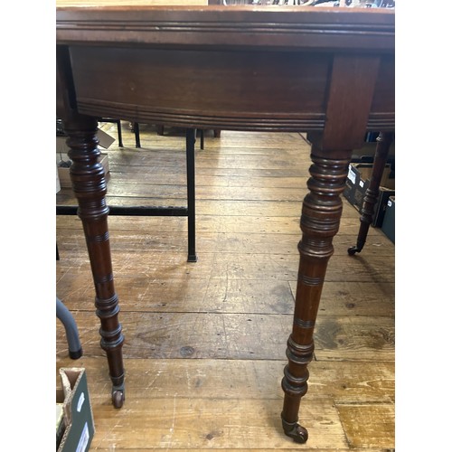 1013 - A mahogany demi-lune tea table, on turned legs, 109 cm wide