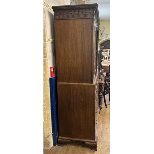 1062 - A 19th century inlaid mahogany linen press, the top having two cupboard doors, on a base with a secr... 