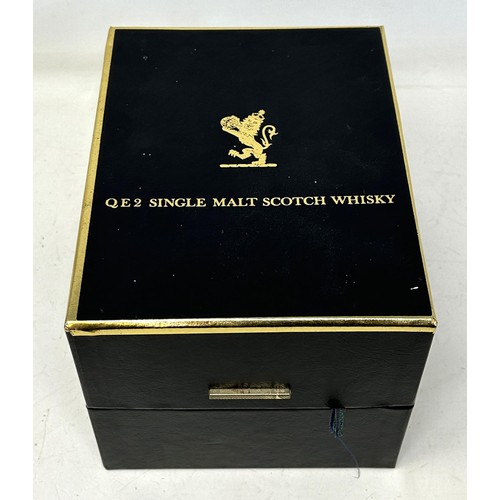 1332 - A commemorative whisky jug, Cunard QE2, containing 12 year old Scotch whisky, in a presentation box