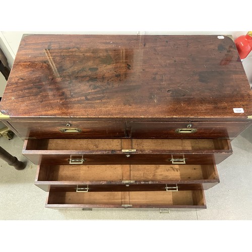 1034 - A mahogany and brass bound military chest, the top having two short and one long drawers, the base w... 