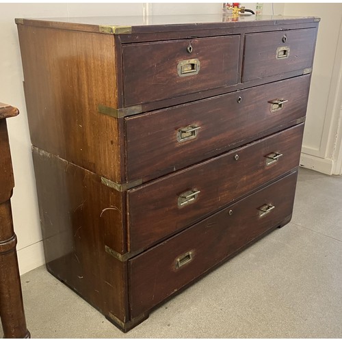 1034 - A mahogany and brass bound military chest, the top having two short and one long drawers, the base w... 