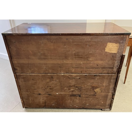 1034 - A mahogany and brass bound military chest, the top having two short and one long drawers, the base w... 