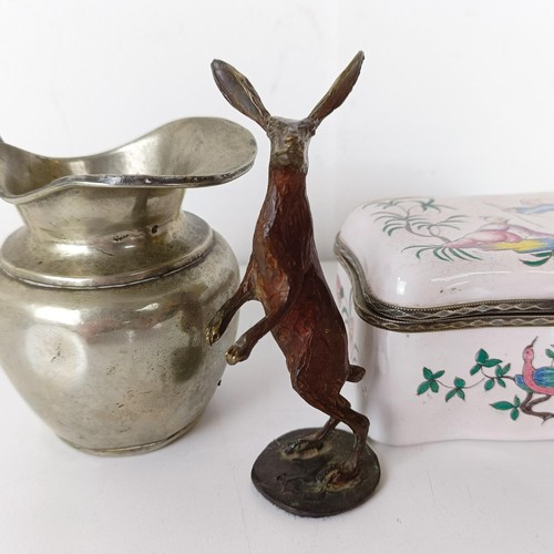 1061 - A bronze figure of a hare, 10 cm high, a silver plated cream jug, and an enamel box, decorated two f... 