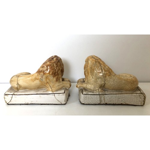 1074 - A pair of pottery lions, on plinth bases, 14 cm wide (2)Provenance: On instructions of the Executors... 