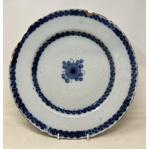 1081 - A blue and white Delft plate, 36 cm diameter and a polychrome Delft plate, decorated parrot, 23 cm d... 